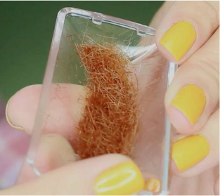 Pile of trimmed split ends hair collected after using split end PRO 2 trimmer