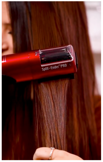 Woman using Split Ender Pro for smooth, healthy hair